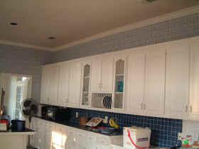The kitchen - before with blue and white wallpaper